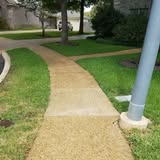 Clean concrete walkway and lawn edge